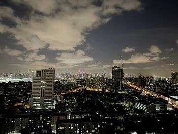 Illuminated buildings against sky in city