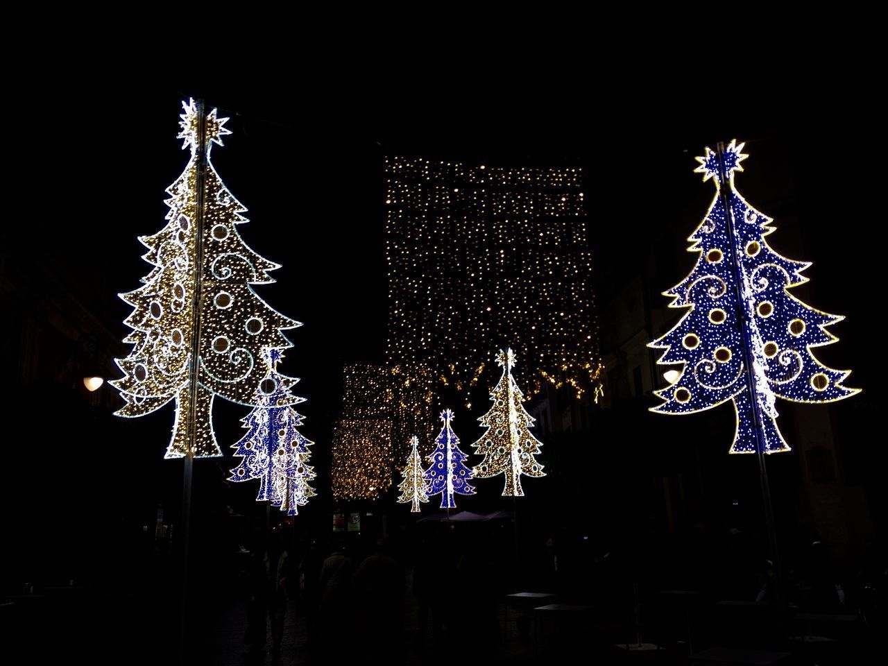 ILLUMINATED CHRISTMAS TREE AT NIGHT DURING FESTIVAL