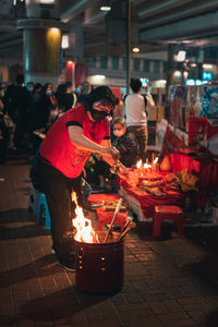 People at market stall at night