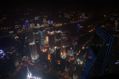 High angle view of illuminated buildings in city at night