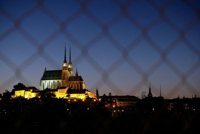 Illuminated buildings in city at dusk