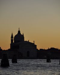 Silhouette church against clear sky during sunset