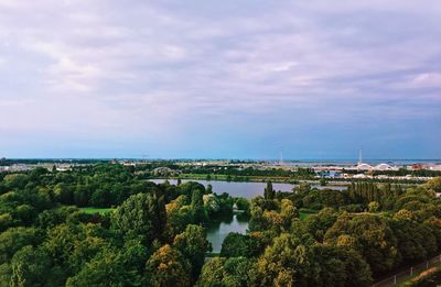 Scenic view of river by trees against sky