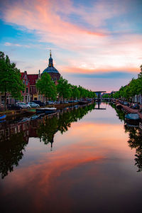 Reflection of building in lake during sunset