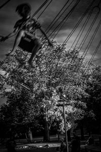 Low angle view of woman on street against sky