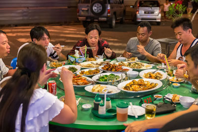 Group of people eating food at restaurant