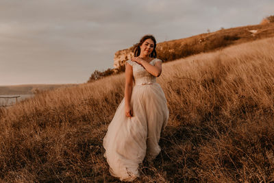 Side view of woman standing on field