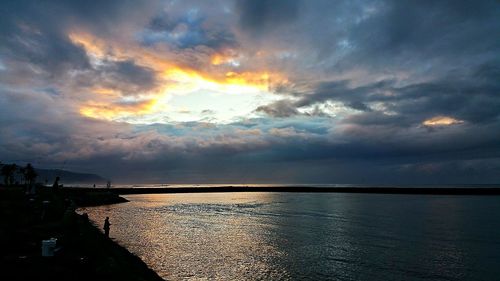 Scenic view of sea against cloudy sky