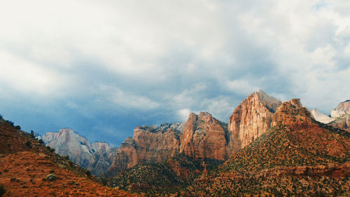 Panoramic view of mountain range against cloudy sky
