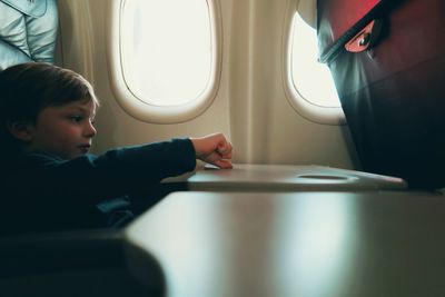 Boy sitting in airplane
