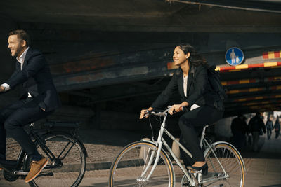 Full length of man riding bicycle in city