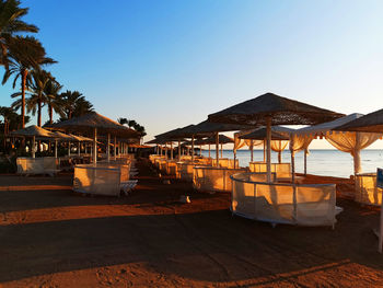 Built structure by swimming pool against clear sky