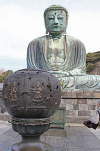 Statue of temple against building