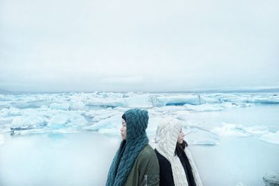 People standing on snow covered landscape