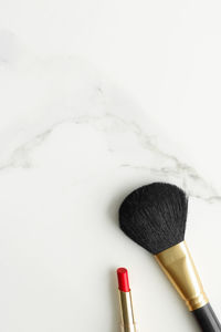 High angle view of make-up brushes on snow