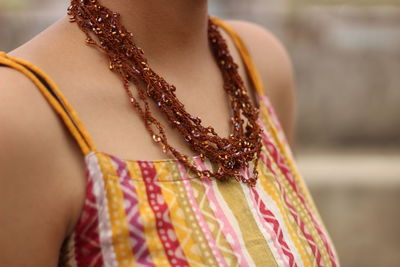 Midsection of woman standing against blurred background