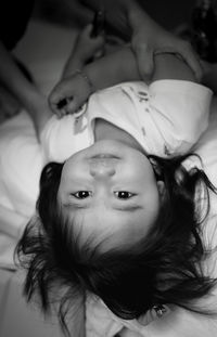 High angle portrait of woman lying on bed