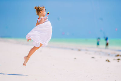 Full length of woman standing at beach