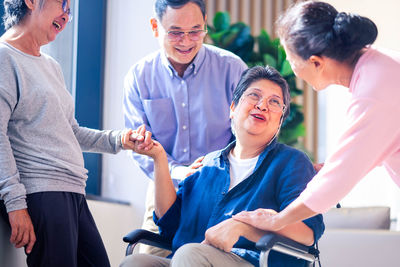 Side view of business colleagues shaking hands at home