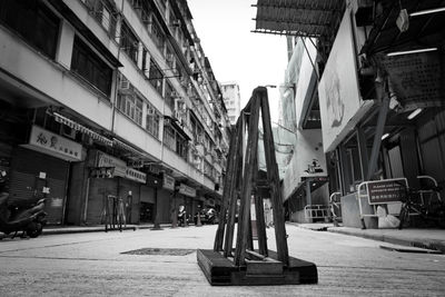 View of empty street amidst buildings in city