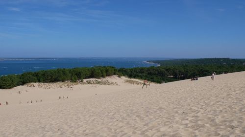 Scenic view of beach against blue sky