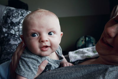 Midsection of mother with son at home