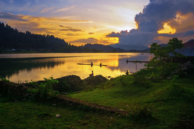 Scenic view of lake against sky during sunset