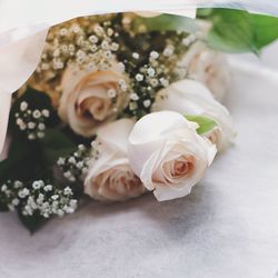 Close-up of rose bouquet on white table