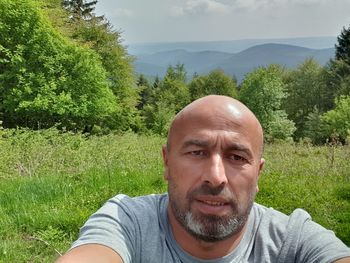 Portrait of man wearing sunglasses against trees