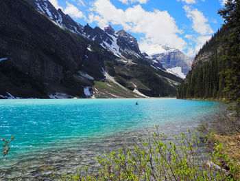 Scenic view of sea and mountains against sky