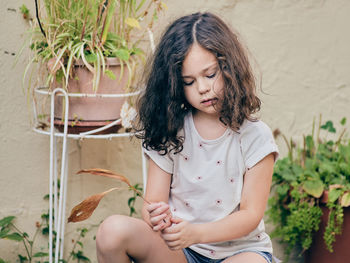 Cute young girl is playing in the backyard