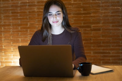 Young woman using laptop at home