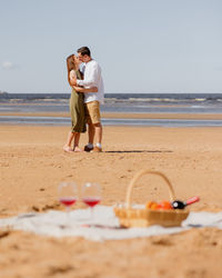 Couple of a man and a woman on a date on the beach by the sea.  walk picnic of two lovers in nature