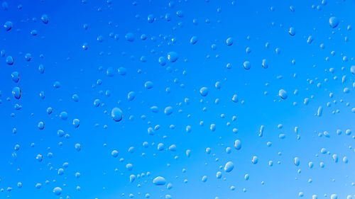 Full frame shot of wet blue window