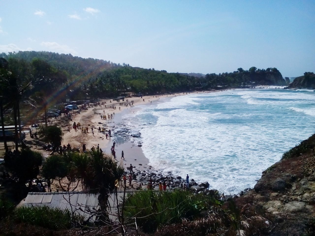 water, sea, beach, scenics, shore, horizon over water, beauty in nature, tranquil scene, tranquility, nature, blue, coastline, tree, sky, clear sky, high angle view, rock - object, idyllic, day, incidental people