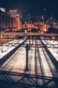 Railway tracks in city at night