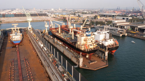 Shipyard and maintenance repair in sea and factory zonne background aerial view