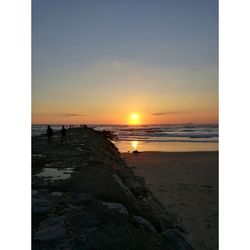 Scenic view of beach against sky during sunset