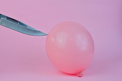 Close-up of balloons against pink background