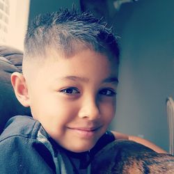 Close-up portrait of smiling boy at home