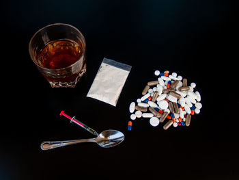 High angle view of drink on table against black background