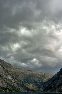 Scenic view of mountain against cloudy sky