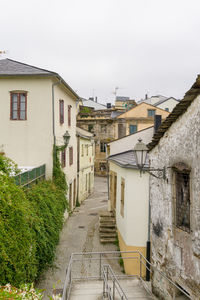 Alley amidst buildings against sky