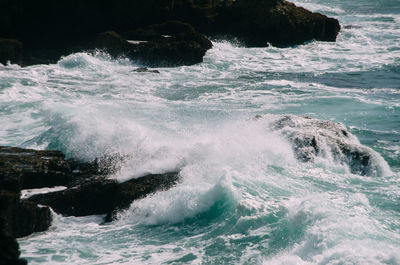 Waves splashing on rocks at shore
