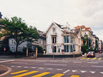 Road by building against sky
