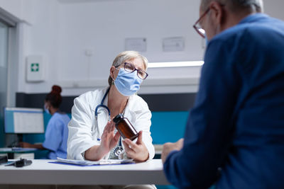 Side view of doctor examining patient in office