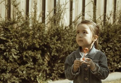 Cute boy holding food outdoors