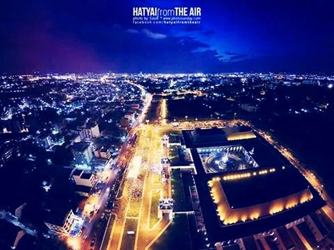 illuminated, night, city, high angle view, building exterior, architecture, cityscape, built structure, city life, transportation, road, traffic, street, car, sky, light trail, city street, dusk, crowded, outdoors