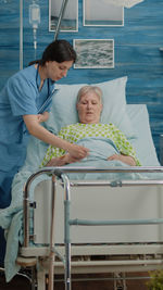 Nurse examining senior patient at clinic