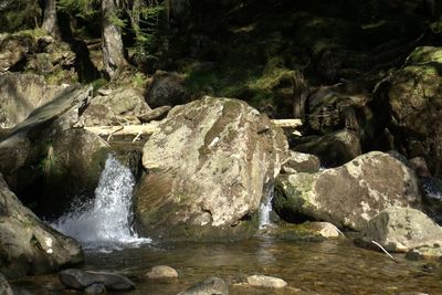 Scenic view of river flowing through rocks